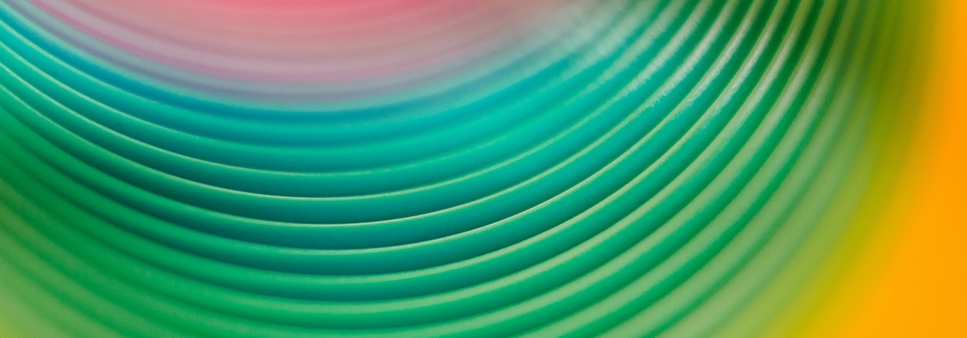 Closeup bright multicolored lines of lovely slinky toy